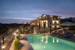 a house with a swimming pool in front of it at Enos Retreat Villas in Agios Nikolaos
