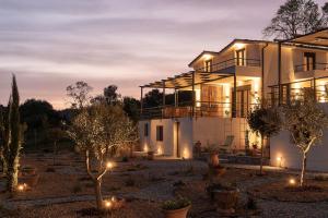 a house with lights in front of it at Enos Retreat Villas in Agios Nikolaos