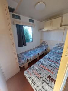 two beds in a small room with a window at Sunny Quiet Nest in Jūrmala