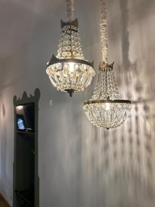 two chandeliers hanging from a wall in a room at B&B del Giglio in Cefalù