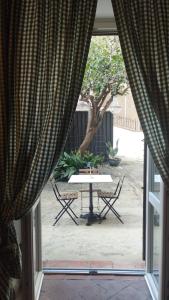 a view of a table and chairs from a window at B&B del Giglio in Cefalù
