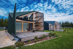 a modular home with a deck and a house at Trzy Siostry Udryn in Udryń