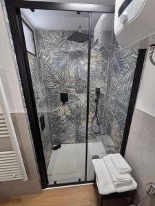 a shower with a glass door in a bathroom at B&B Del Paradiso in Bergamo +30 photos