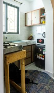a kitchen with a table and a stove in it at Artist sanctuary lakeview phase4 in Mto Panga