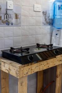 a stove top oven sitting on top of a wooden table at Artist sanctuary lakeview phase4 in Mto Panga