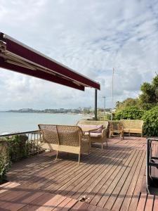 a deck with chairs and a view of the water at Kuba pansiyon in Side