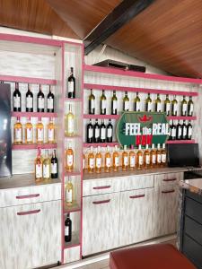 a room with bottles of wine on the wall at Kuba pansiyon in Side +28 photos
