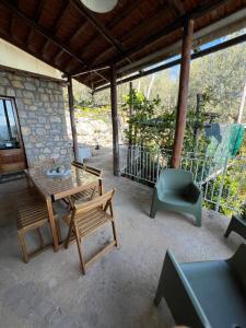 a patio with a wooden table and chairs on it at La Petra in Vico Equense