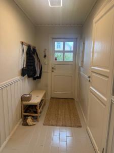 a hallway with a white door and a rug at Central Home in Mandal in Mandal