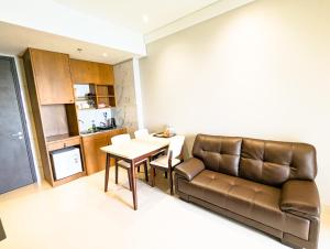 a living room with a couch and a table at Lovina 20-AE at One Residence in Batam Center