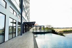an external view of a building with a swimming pool at Lovina 20-AE at One Residence in Batam Center
