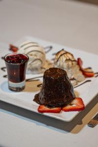 a plate of chocolate cake and strawberries on a table at Gran Hotel Miglierina in Mar del Plata