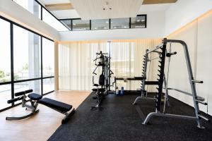 a gym with two treadmills and two tread machines at Lovina 20-AE at One Residence in Batam Center
