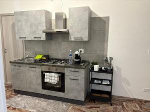 a kitchen with a stove top oven in a room at Le Regioni Del Cuore in Vieste