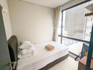 a small bedroom with a bed and a window at Lovina 3-AH at One Residence in Batam Center