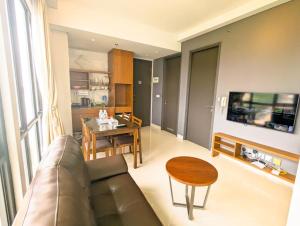 a living room with a couch and a table at Lovina 3-AH at One Residence in Batam Center