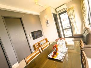a living room with a dining room table with chairs at Lovina 3-AH at One Residence in Batam Center