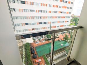 a view from a window of a building with a pool at Lovina 3-AH at One Residence in Batam Center