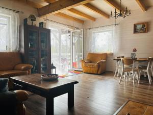 a living room with a table and a dining room at Dom wakacyjny nad jeziorem, Mazury in Samin