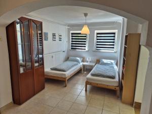 a living room with two beds and a table at Ferienwohnung Anja in Sonneberg