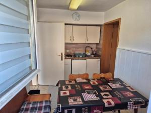 a kitchen with a table with a table cloth on it at Ferienwohnung Anja in Sonneberg