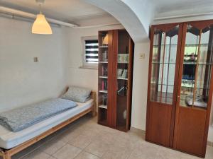 a room with two beds and a book shelf at Ferienwohnung Anja in Sonneberg
