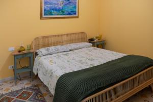 a bedroom with a bed and two night stands at Appartamento l'Isola D'Oro in Grado