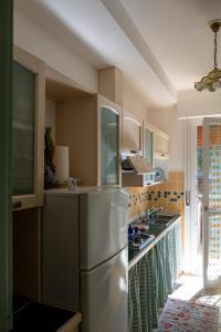 a kitchen with a stainless steel refrigerator at Appartamento l'Isola D'Oro in Grado +14 photos