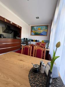 a dining room with a table with a vase on it at Hotel Aleksander in Ustka