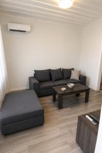 a living room with a couch and a coffee table at Perioptron Guesthouse Ithaca in Vathi
