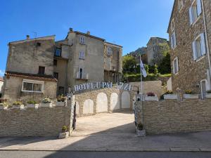 an entrance to an old building with a gate at Hôtel U Palazzu & Spa - Centre du village in Venaco