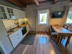 a kitchen with a table and a dining room at Pension Müllers Mühle in Großenhain