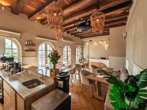 a kitchen and dining room with wooden ceilings and chandeliers at Casa Bugó Arsenal Hotel Boutique en Getsemaní in Cartagena de Indias