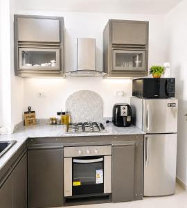 a kitchen with stainless steel appliances and a refrigerator at Sea La Vie Villa in Grande Gaube