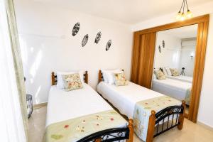 two beds in a room with a mirror at Sea La Vie Villa in Grande Gaube +27 photos