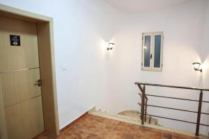 a room with a staircase and a door and a stair case at Berat Hill Hostel in Berat