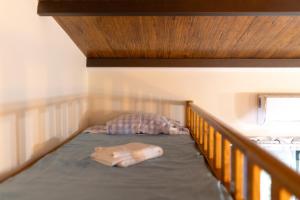 a bed in a room with a wooden bed frame at Casinha de campo in Geres +22 photos