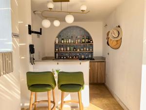 two green chairs at a bar in a room at Casa Bugó Arsenal Hotel Boutique en Getsemaní in Cartagena de Indias +94 photos