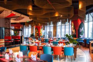 a dining room with tables and chairs in a restaurant at Panorama Blue Beach Nha Trang in Nha Trang