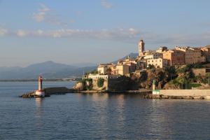 a small lighthouse in the middle of a body of water at Maison TORTONI in Bastia