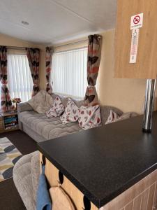 a kitchen with a couch in a living room at Sleeps 8 guests lovely 3 Bedroom Golden Gate Towyn in Llanddulas +41 photos