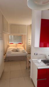 a bedroom with a bed with red and white at Messapia Homes in Mesagne