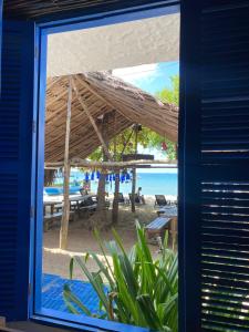 a view of the beach from a window of a beach at Casa Violeta Beach House in Rincón