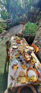 a picnic table with plates of food on it at Rifugio Capo D,acqua in Positano