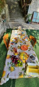 a table with fruits and plates of food on it at Rifugio Capo D,acqua in Positano