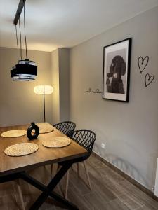 a dining room table with chairs and a picture on the wall at Las Casas de Lola in Candeleda