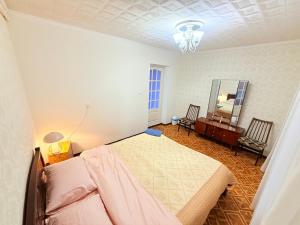 a bedroom with a bed and a dresser and a mirror at Одноместный номер на ключ в хостеле Single Hostel Room in Chişinău