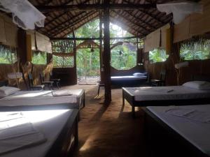 a room with three beds in a room with trees at Moonshade Handapanagala in Monaragala +196 photos