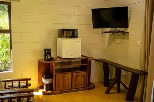 a room with a small refrigerator and a table at Riverside Villas in Manuel Antonio