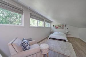 a living room with a couch and a bed at Secluded River Cabin Near Sly Park & Apple Hill in Placerville